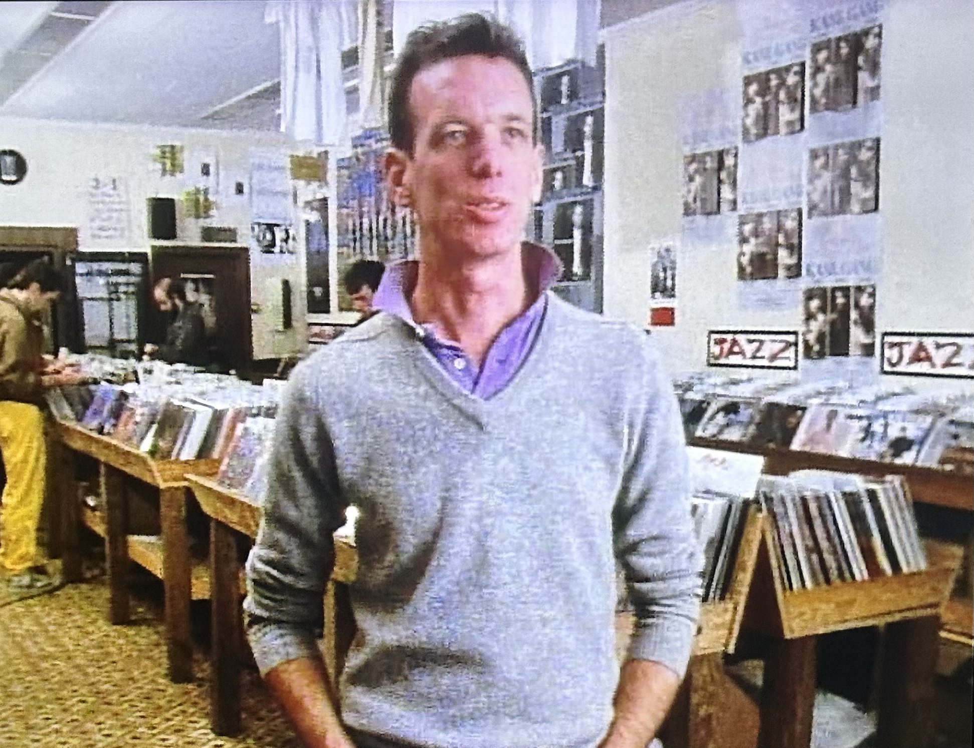 man stands in 1980s records store
