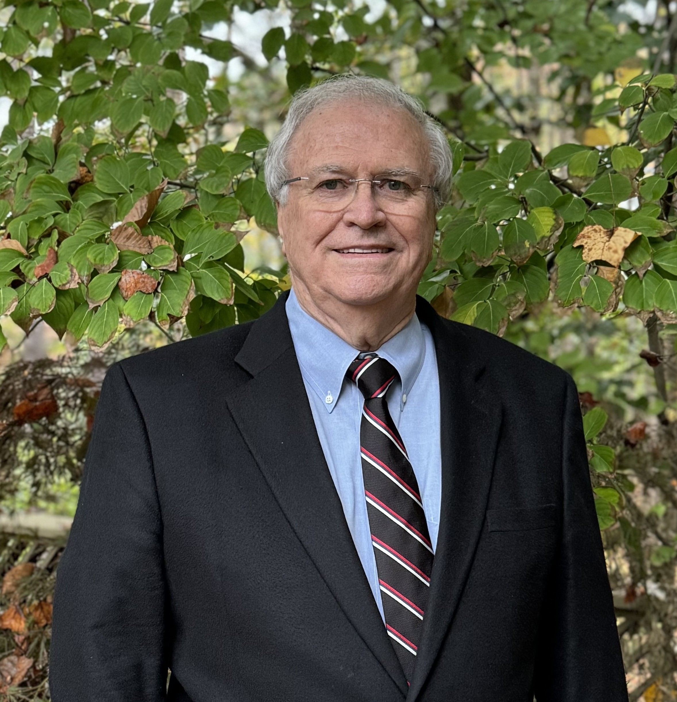 Photo of white-haired man with glasses