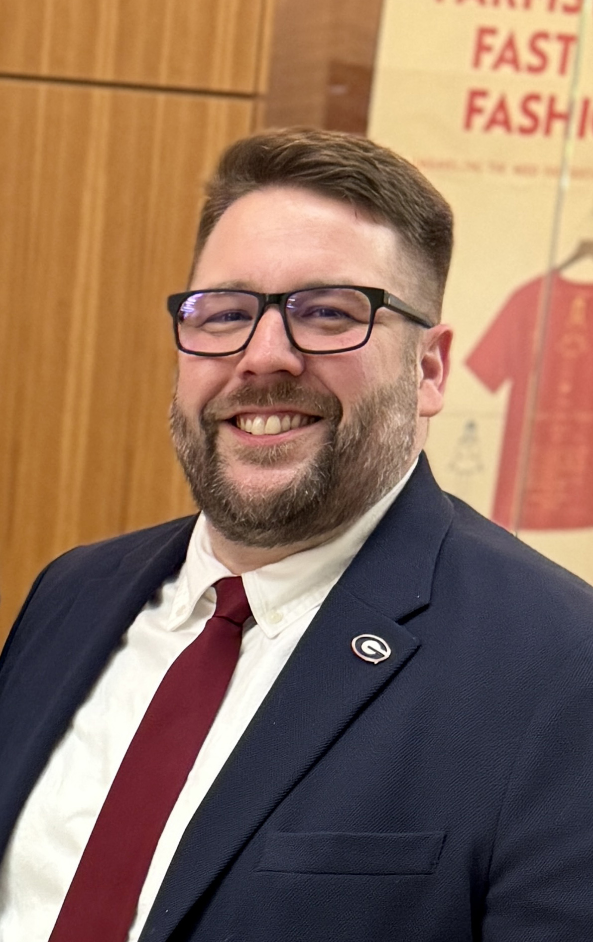 Man with glasses smiles