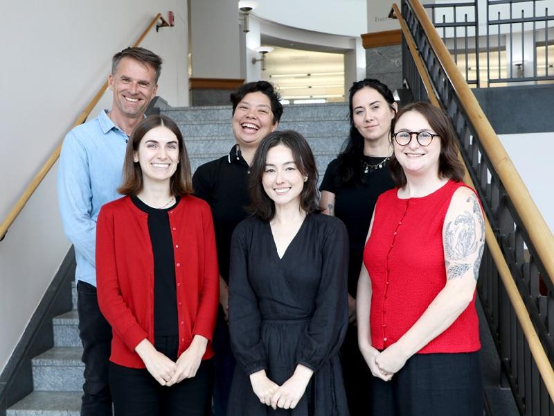 group of student success librarians standing together in front of stairs at the Miller Learning Center