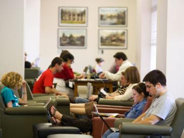 Students sitting in soft chairs and studying.